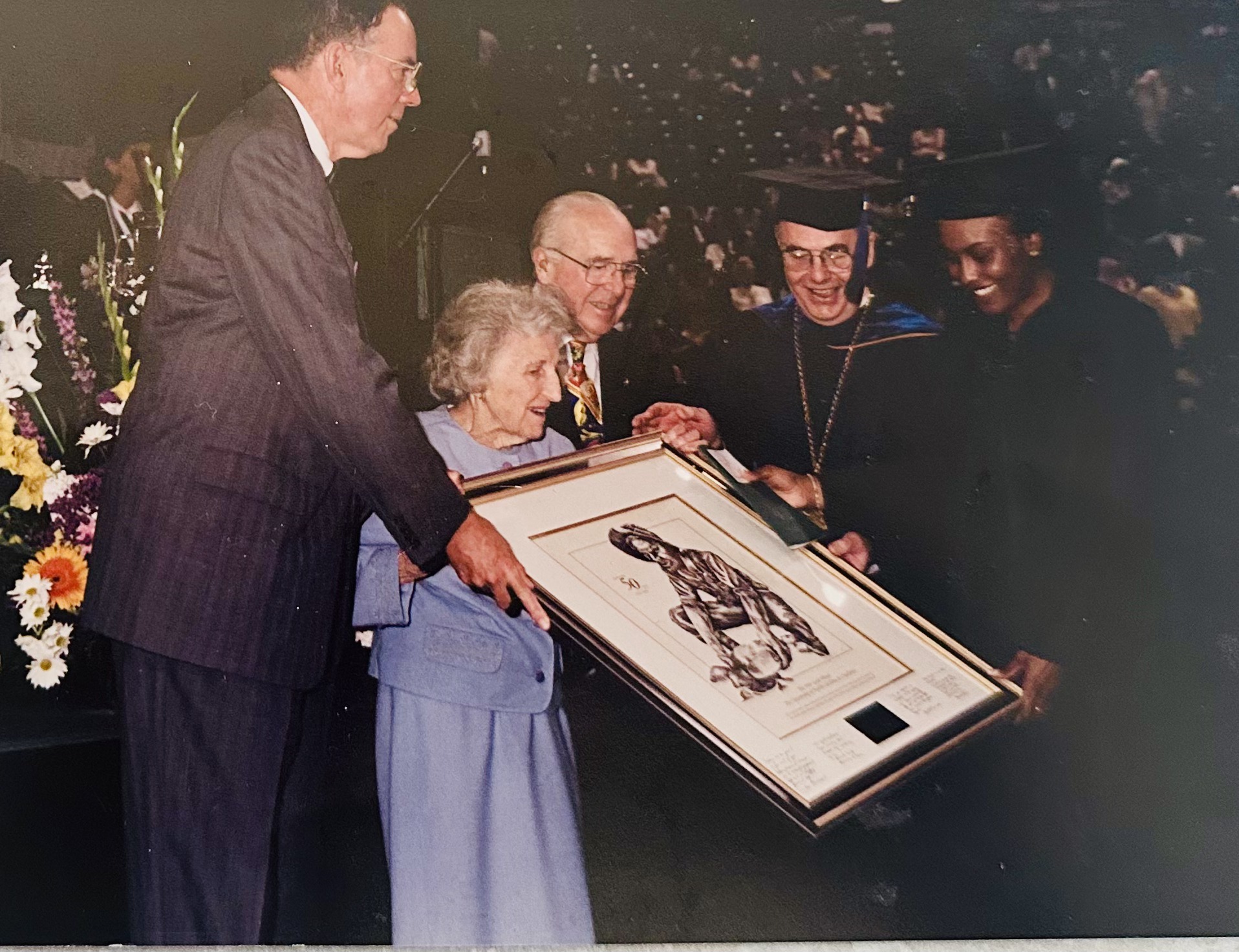 Tracy Sanders receiving the 49er Gold Miner plaque from Bonnie Cone and the chancellors of UNC Charlotte